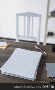 Stack sheet of paper on wooden desk table. Office or study creative concept