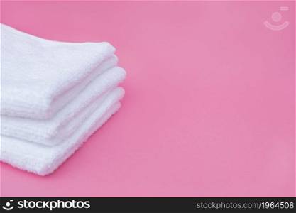 stack white towels pink background. High resolution photo. stack white towels pink background. High quality photo
