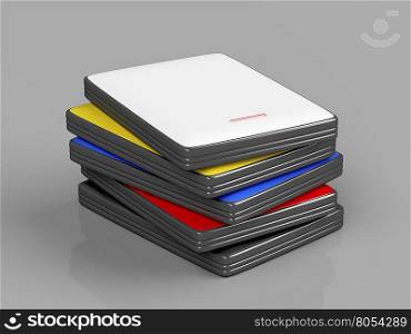 Stack with portable hard drives with different colors on shiny gray background