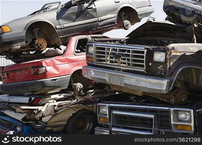 Stacked cars in junkyard