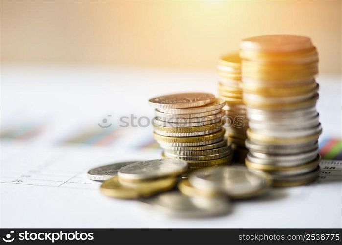 stacked coins financial and business man on business graph paper analysis of business investment concept money