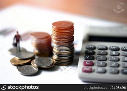 stacked coins financial and business man on business graph paper with calculator analysis of business investment concept money