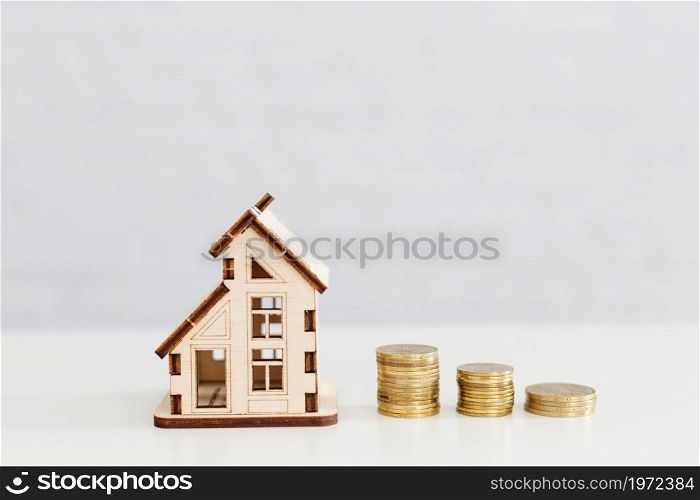 stacked coins wooden home. High resolution photo. stacked coins wooden home. High quality photo