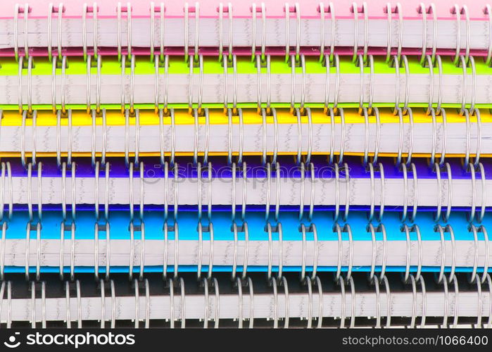 Stacked colorful notebooks isolated over white background