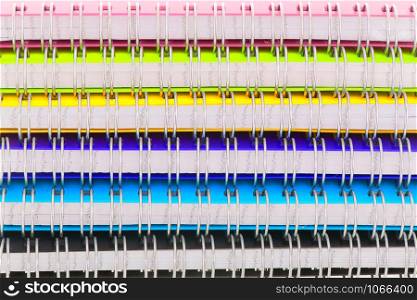 Stacked colorful notebooks isolated over white background