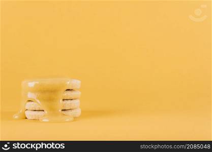 stacked cookies with lemon curd yellow background