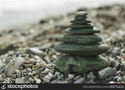 Stacked green sea stones