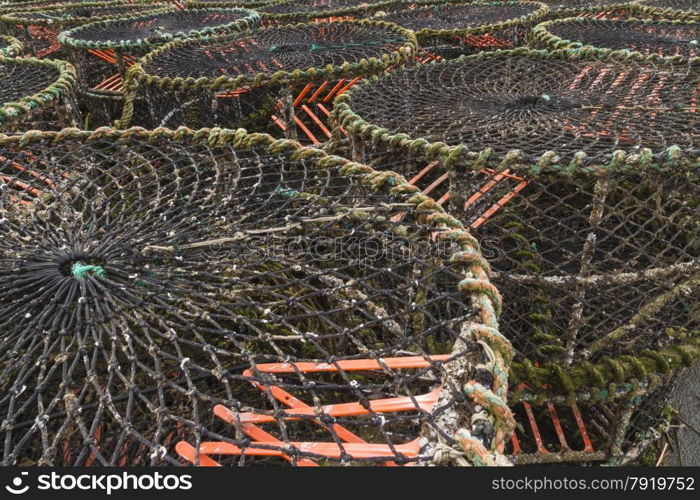 Stacked lobster pots, with buoys on Mudeford Quay, Christchurch, Dorset, England, United Kingdom