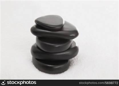 Stacked massage stones on a towel