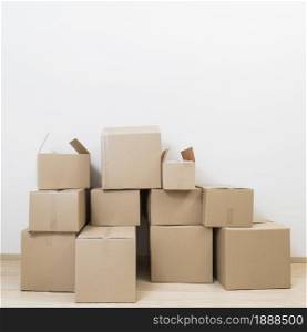 stacked moving cardboard boxes against white wall. Resolution and high quality beautiful photo. stacked moving cardboard boxes against white wall. High quality and resolution beautiful photo concept