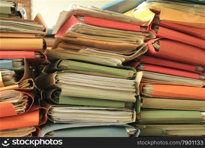 Stacked office files: pile of paperwork in an office