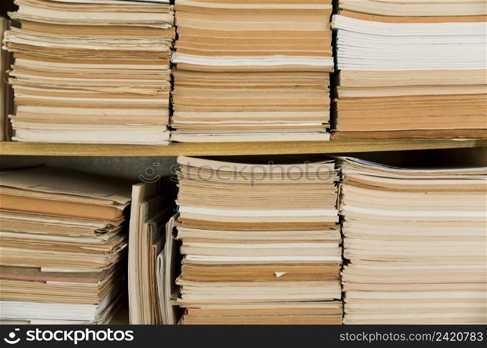 stacked old notepads shelf