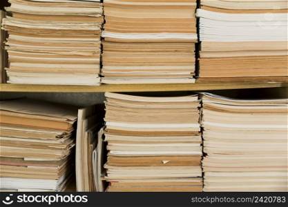 stacked old notepads shelf