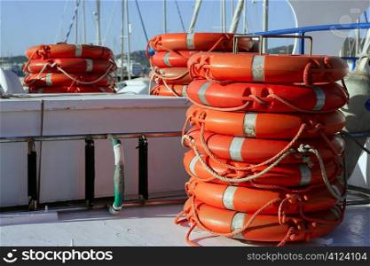 Stacked orange rescue round buoy, sea marine lifesaver