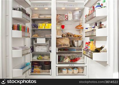 Stacked products in open fridge