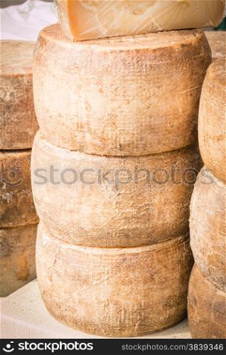 stacked rounded cheese for sale in local market