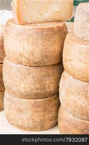 stacked rounded cheese for sale in local market