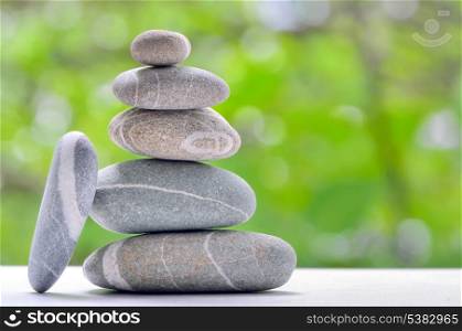 Stacked stones on a green natural background
