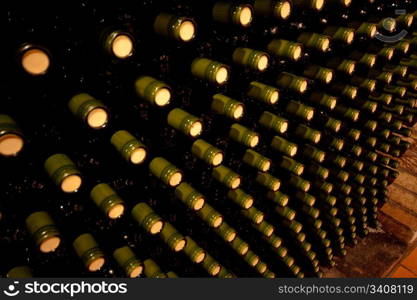 stacked up wine bottles in the cellar