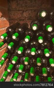 stacked up wine bottles in the cellar