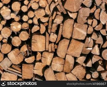 stacked wood as firewood in a forest. heating with wood stove