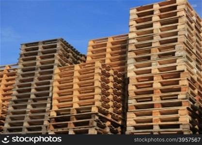 Stacked wooden pallets at a storage