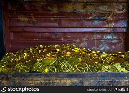 Stacking Gold Coin in treasure chest on black background