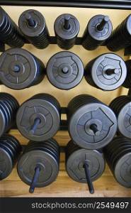 Stacks of barbell weights at gym.