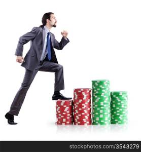 Stacks of casino chips and climbing businessman