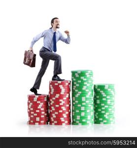 Stacks of casino chips and climbing businessman