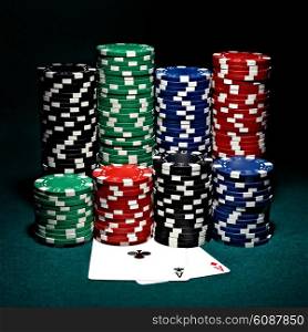 stacks of chips for poker with pair of aces