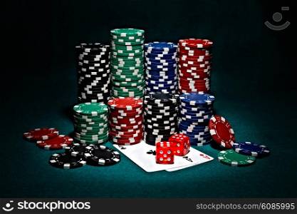stacks of chips for poker with pair of aces and dice