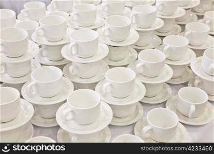 Stacks of coffee cups on saucers