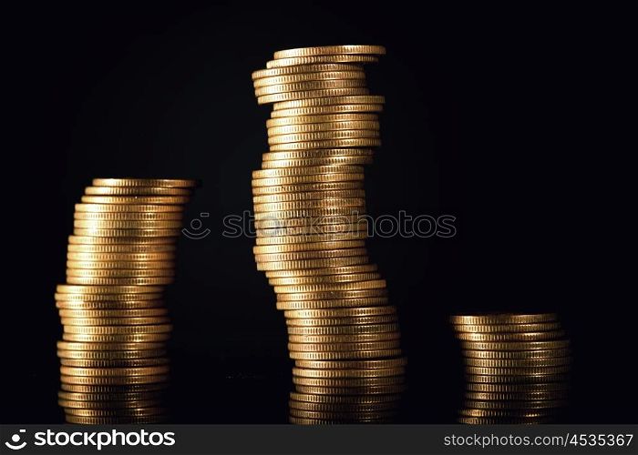 Stacks of coins isolated on black background, financial graph concept