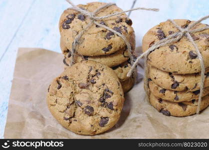 Stacks of homemade chocolate chip cookies on wooden table