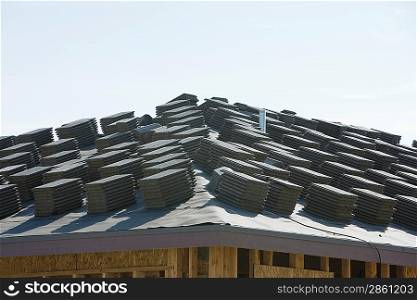 Stacks of tiles on building roof