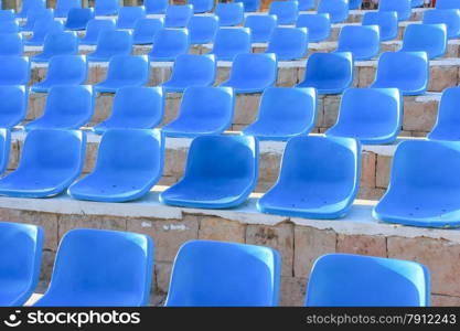 Stadium Blue Chairs at sun light.