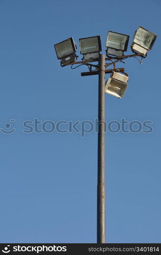 stadium lights pole against blue sky background