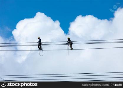 staff installation and modification of high voltage electrical cable system and cloud sky background Thailand