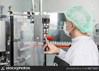 Staff workers working operate control machine in hygiene food factory.