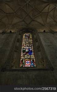 Stained glass window inside Mosteiro dos Jeronimos in Lisbon, Portugal.