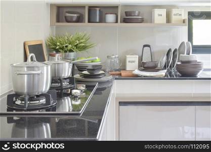 Stainless pots and ceramic ware setting on the counter in the kitchen