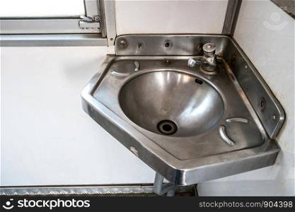 Stainless steel sink in the corner on the train.