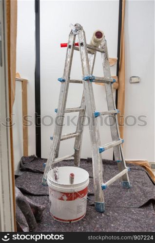 Staircase and Tools for Painting and Floor Covered with Protective Sheeting.. Staircase and Tools for Painting and Floor Covered with Protective Sheeting