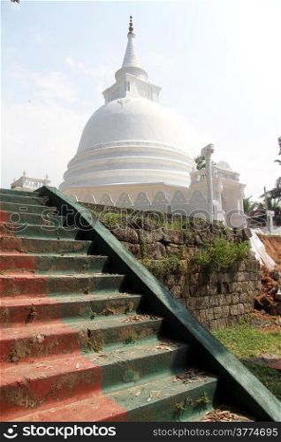 Staircase and white stupa in Sapugoda temple in Beruwala, Sri Lanka