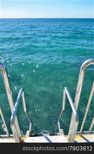 Staircase into the water for a bath in the wide ocean