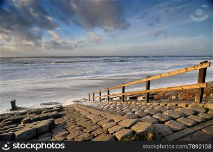 Stairs at seaside in Holland during storm