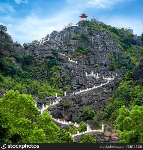 Stairway at limestone mountain to Hang Mua view point. Popular tourist attraction at Tam Coc, Ninh Binh. Vietnam travel landscapes and destinations