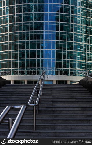 Stairway with steel handrails lead up to entrance of office building.