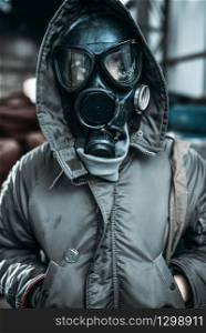 Stalker concept, male person in gas mask, radiation danger. Post apocalyptic lifestyle, doomsday, horror of nuclear war